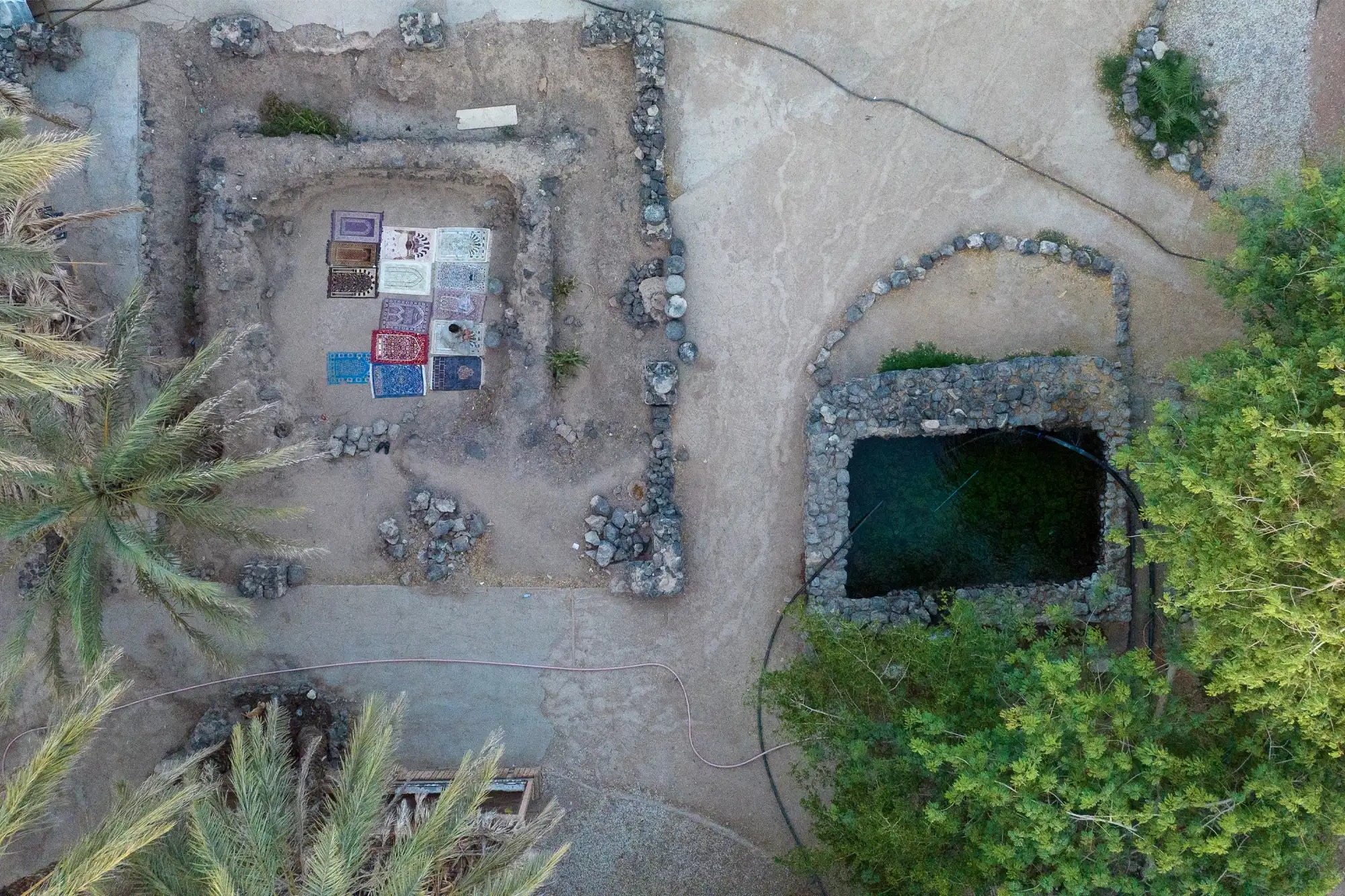 Close-up of the historic stone structure at Athq Well